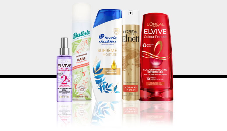A collection of hair care products including shampoo, conditioner, dry shampoo, and styling spray from brands like L'Oreal and Batiste.